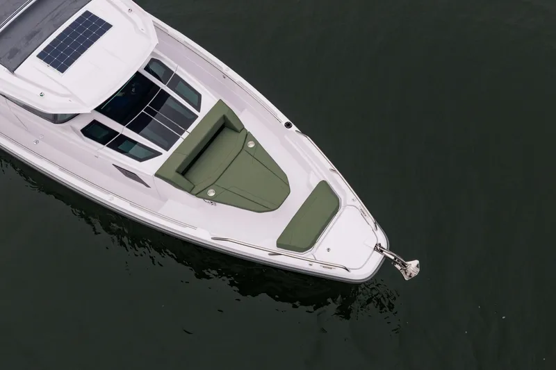 Slide: The Image of Aerial view of 2026 Axopar 38 Cross Cabin boat with green seating. - 12