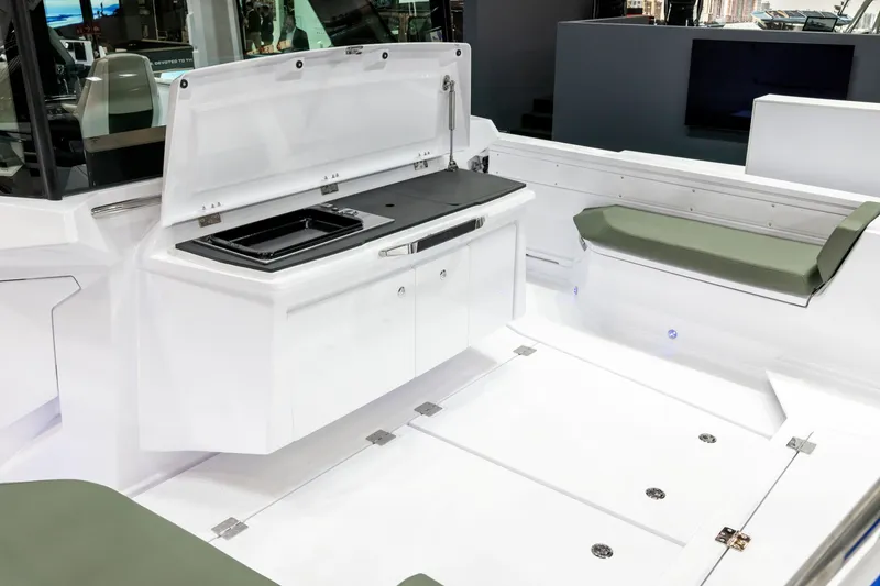 Slide: The Image of 2026 Axopar 38 Cross Cabin interior with sleek white cabinetry and seating. - 15