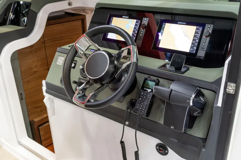 Slide: The Image of 2026 Axopar 38 Cross Cabin helm with dual Simrad displays and modern controls. - 17