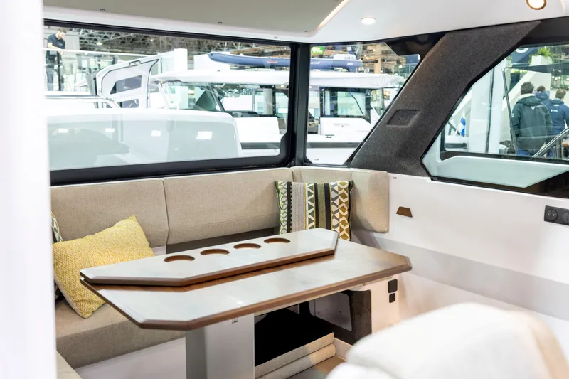 Slide: The Image of Interior of 2026 Axopar 38 Cross Cabin with modern seating and table. - 20