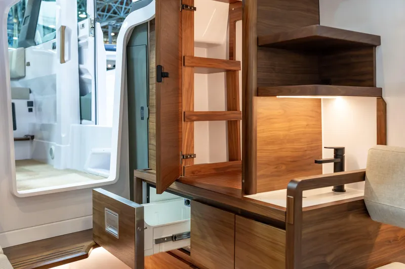 Slide: The Image of Luxurious interior of 2026 Axopar 38 Cross Cabin with wooden cabinetry and modern fixtures. - 22
