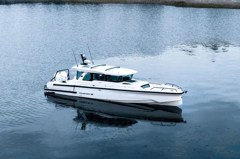 Slide: The Image of Axopar 38 Cross Cabin 2026 on calm water. - 7