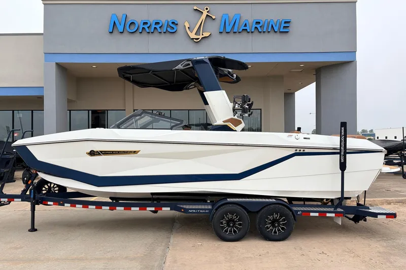 The Image of 2026 Nautique Super Air Nautique G25 boat on trailer at Norris Marine dealership. - 1