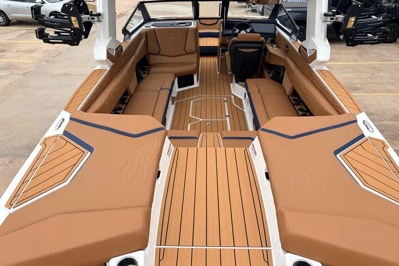 Slide: The Image of 2026 Nautique Super Air Nautique G25 interior with tan upholstery and sleek design. - 11