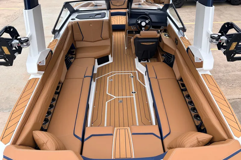 Slide: The Image of 2026 Nautique Super Air Nautique G25 interior with luxurious tan seating and sleek design. - 12