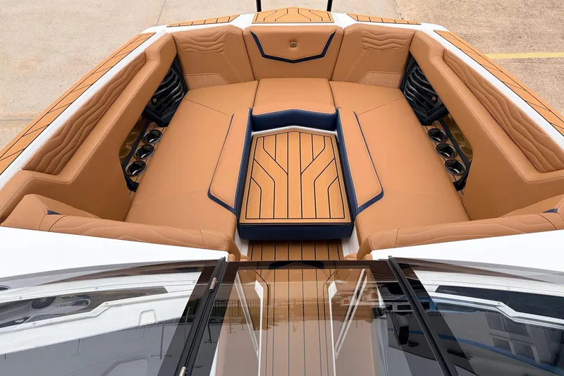 Slide: The Image of Luxurious interior of 2026 Nautique Super Air Nautique G25 boat with tan seating. - 13