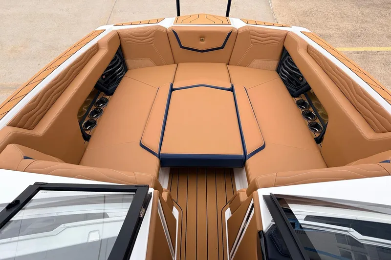 Slide: The Image of Luxurious interior of 2026 Nautique Super Air Nautique G25 boat with tan seating. - 14
