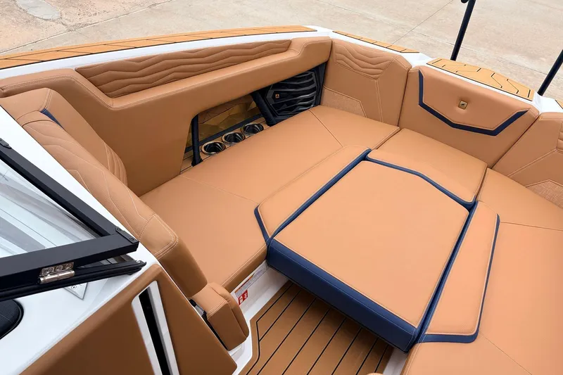 Slide: The Image of Luxurious interior of 2026 Nautique Super Air Nautique G25 boat with tan seating. - 15
