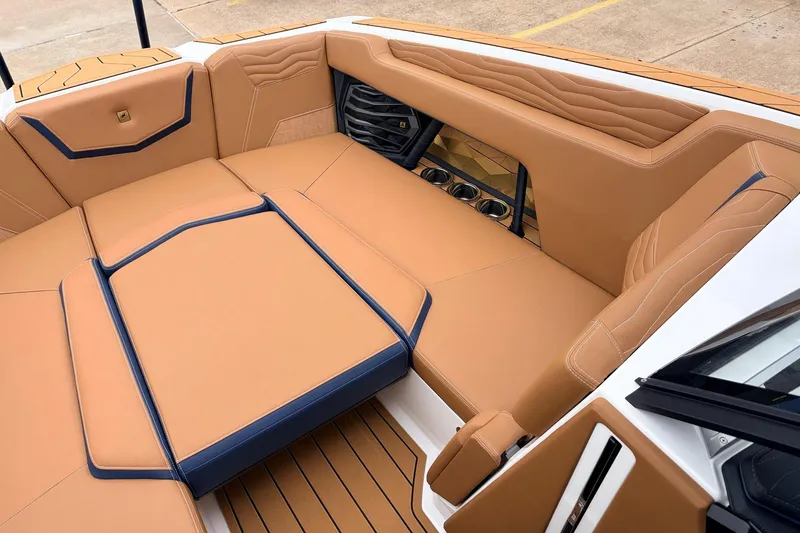 Slide: The Image of Luxurious interior of 2026 Nautique Super Air Nautique G25 boat with tan upholstery. - 16