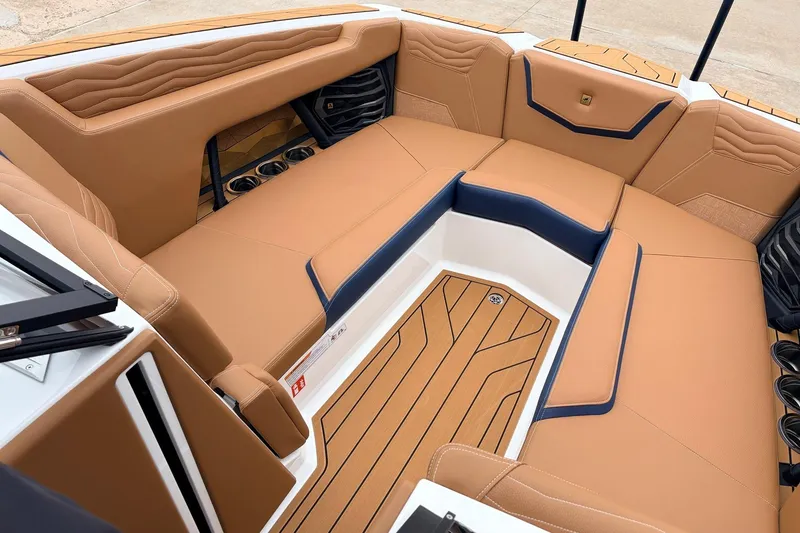 Slide: The Image of Luxurious interior of 2026 Nautique Super Air Nautique G25 boat with tan seating. - 18