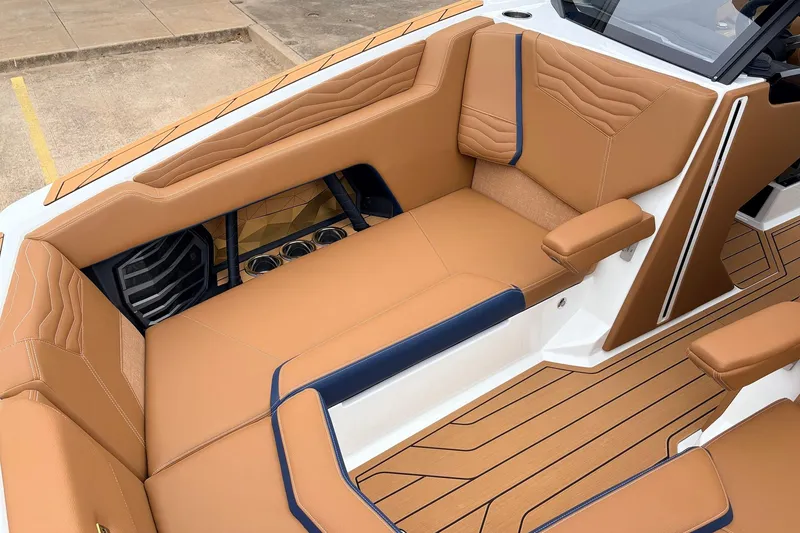 Slide: The Image of 2026 Nautique Super Air Nautique G25 interior with tan leather seating and modern design. - 21