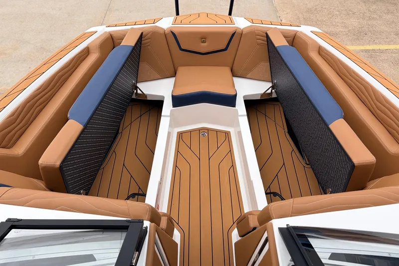 Slide: The Image of Luxurious interior of 2026 Nautique Super Air Nautique G25 boat with tan and blue seating. - 26