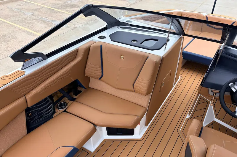 Slide: The Image of 2026 Nautique Super Air Nautique G25 interior with tan leather seating and sleek design. - 28