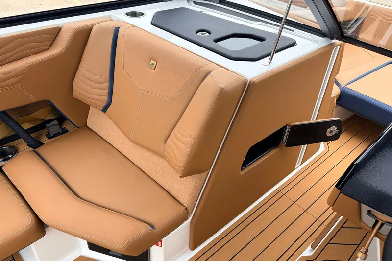 Slide: The Image of 2026 Nautique Super Air Nautique G25 interior with tan leather seating and sleek design. - 29