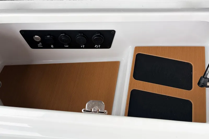 Slide: The Image of 2026 Nautique Super Air Nautique G25 interior compartment with control panel and wooden flooring. - 31