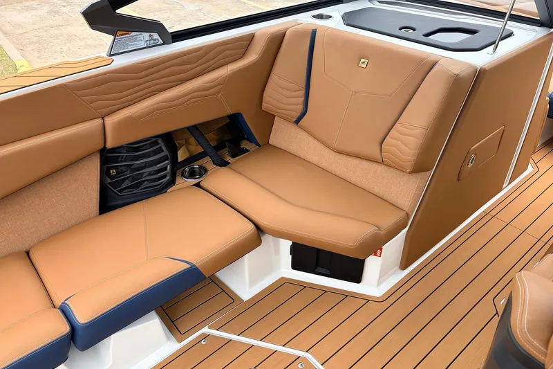 Slide: The Image of 2026 Nautique Super Air Nautique G25 interior with tan leather seating and sleek design. - 32