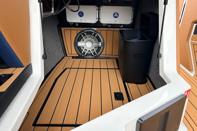 Slide: The Image of 2026 Nautique Super Air Nautique G25 interior with premium audio system and teak flooring. - 34