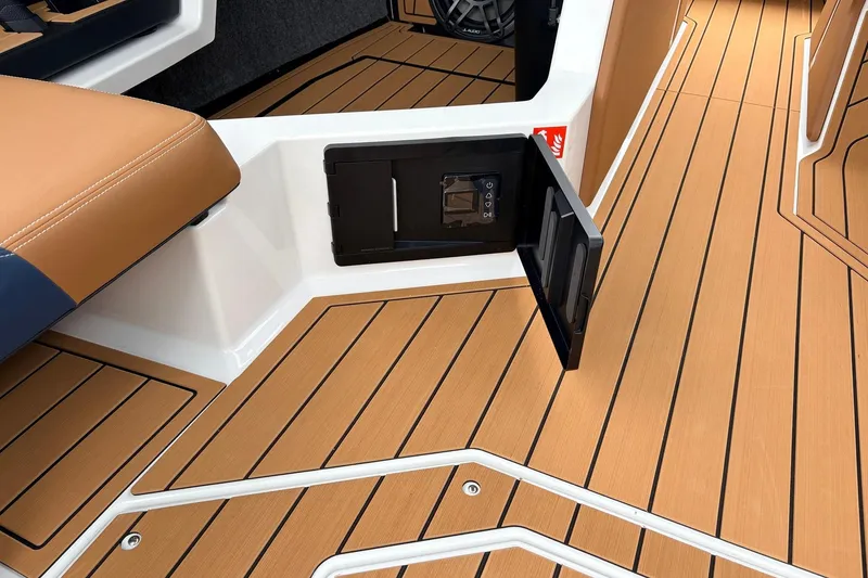 Slide: The Image of 2026 Nautique Super Air Nautique G25 interior with teak flooring and storage compartment. - 36