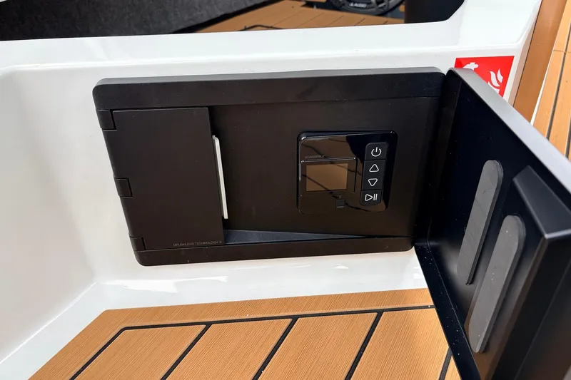 Slide: The Image of Control panel on 2026 Nautique Super Air Nautique G25 boat, featuring sleek black design. - 38