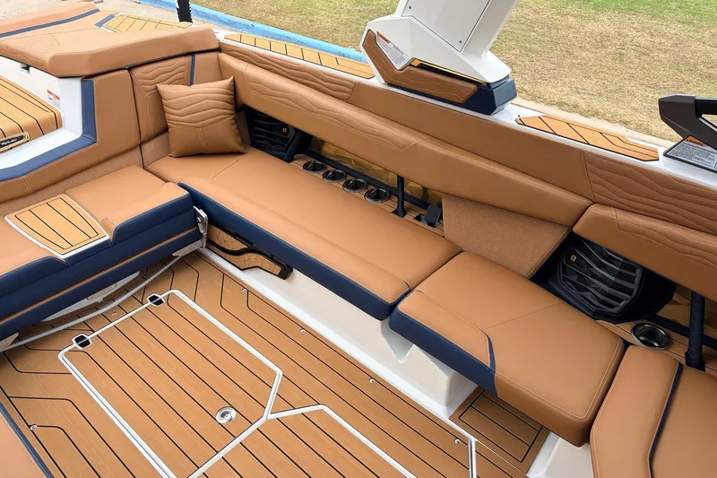 Slide: The Image of Luxurious interior of 2026 Nautique Super Air Nautique G25 boat with tan seating. - 40
