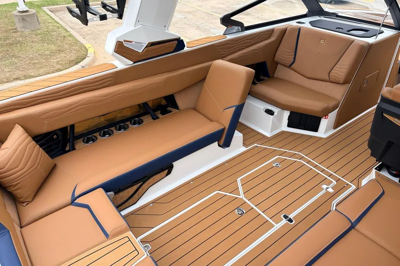 Slide: The Image of 2026 Nautique Super Air Nautique G25 interior with tan leather seating and teak flooring. - 41