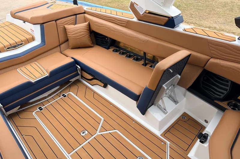 Slide: The Image of Luxurious interior of 2026 Nautique Super Air Nautique G25 boat with tan and navy seating. - 42