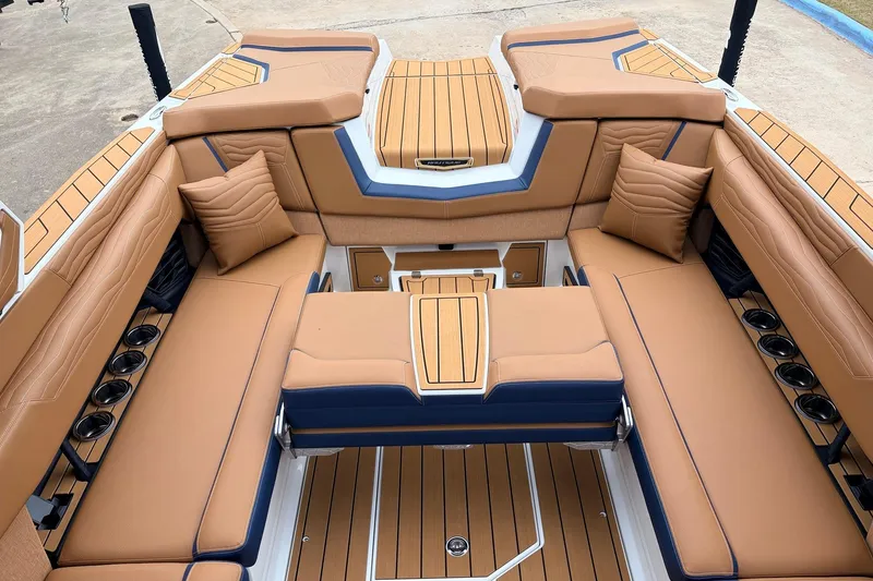 Slide: The Image of Luxurious interior of 2026 Nautique Super Air Nautique G25 boat with tan seating. - 44