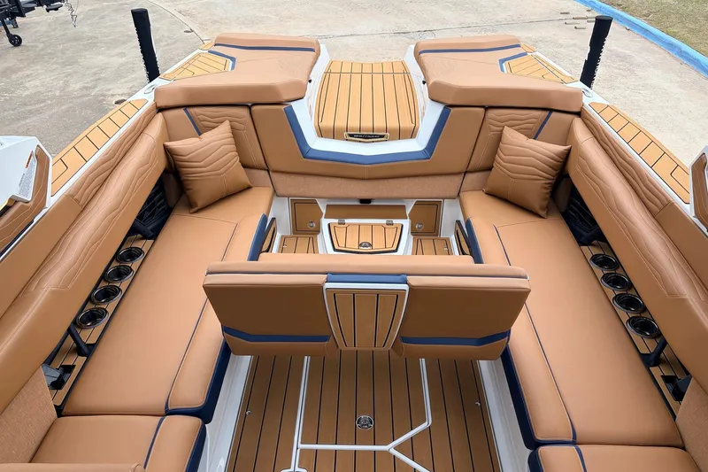 Slide: The Image of Luxurious interior of 2026 Nautique Super Air Nautique G25 boat with tan seating. - 45