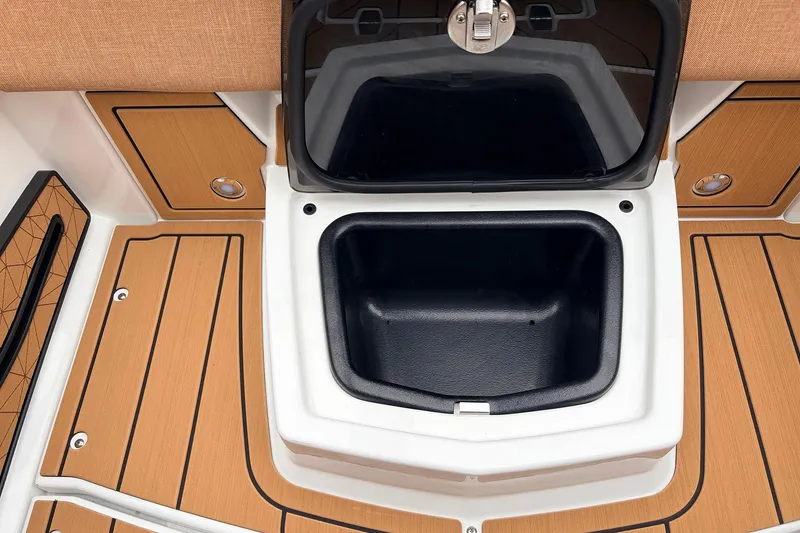 Slide: The Image of 2026 Nautique Super Air Nautique G25 storage compartment with teak-style flooring. - 47