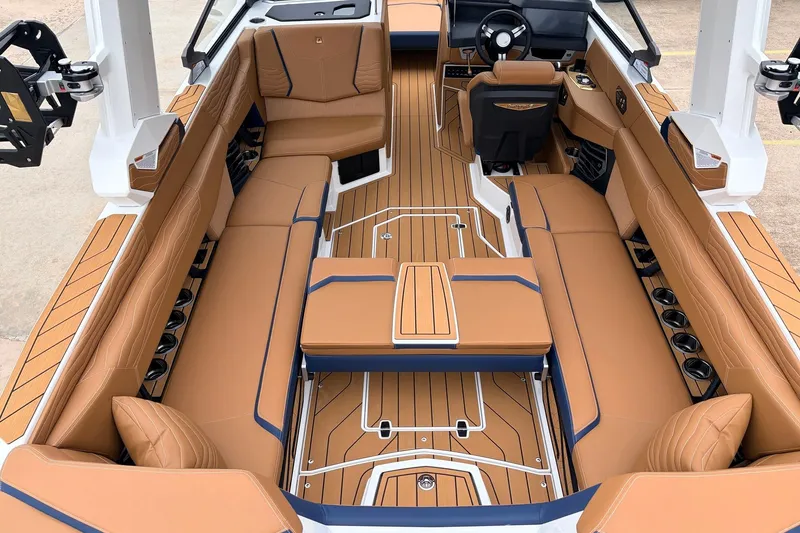 Slide: The Image of 2026 Nautique Super Air Nautique G25 interior with luxurious tan seating and sleek design. - 48