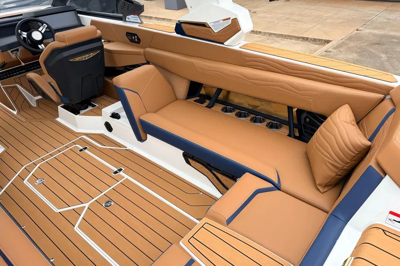 Slide: The Image of 2026 Nautique Super Air Nautique G25 interior with tan leather seating and sleek design. - 52