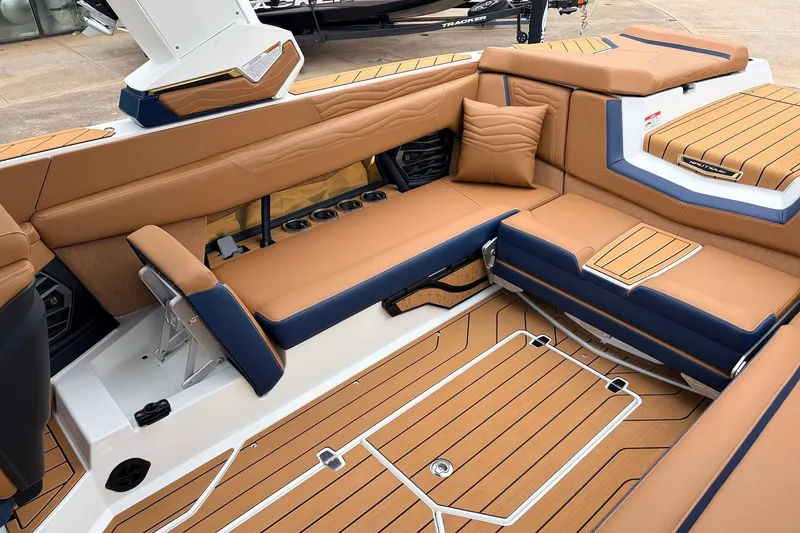 Slide: The Image of Luxurious interior of 2026 Nautique Super Air Nautique G25 boat with tan and navy seating. - 53