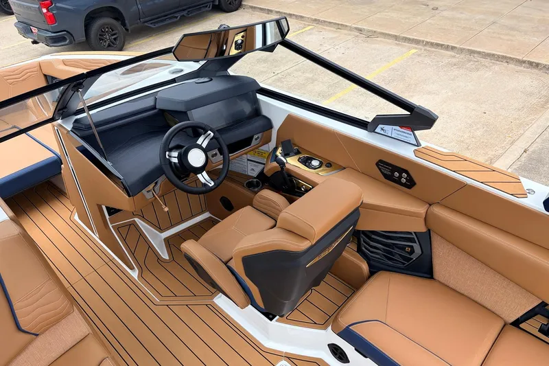 Slide: The Image of 2026 Nautique Super Air Nautique G25 interior with tan upholstery and modern dashboard design. - 54