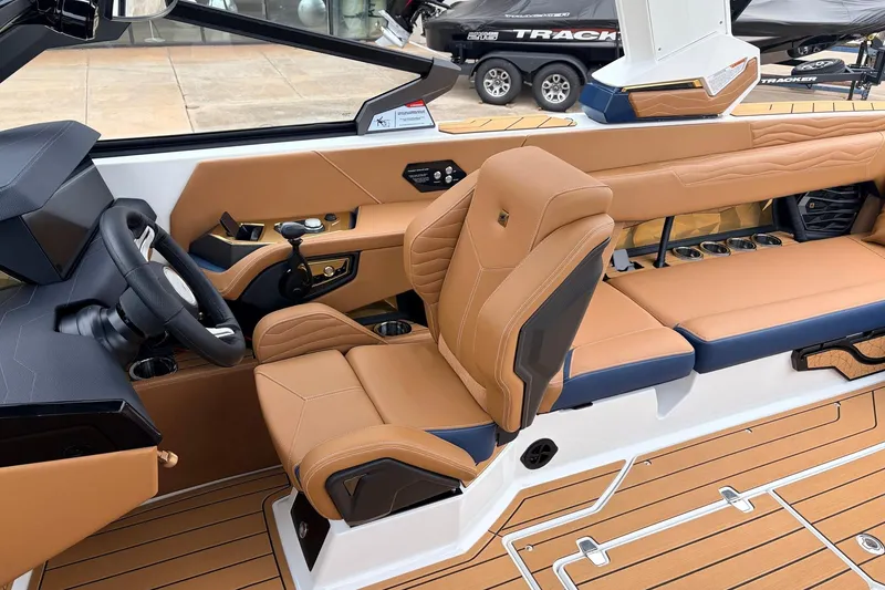 Slide: The Image of 2026 Nautique Super Air Nautique G25 interior with tan leather seats and modern dashboard. - 55