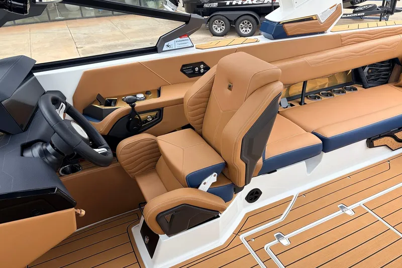 Slide: The Image of 2026 Nautique Super Air Nautique G25 interior with tan leather seats and modern dashboard. - 56