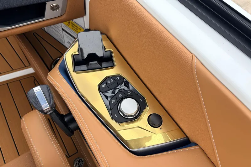 Slide: The Image of Control panel of 2026 Nautique Super Air Nautique G25 with luxurious tan leather accents. - 58