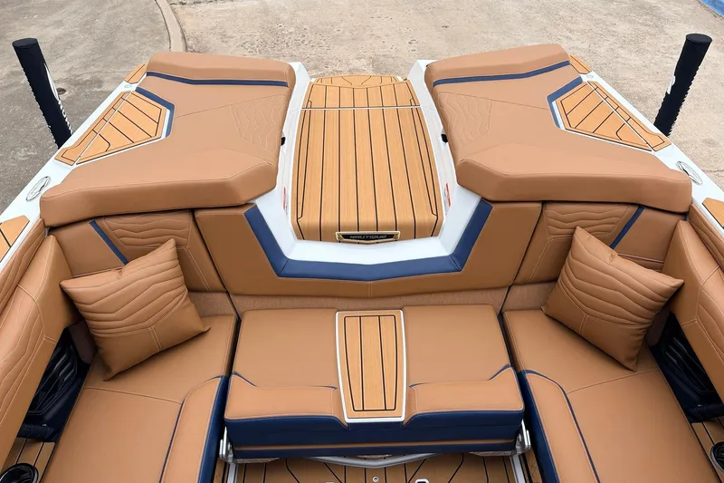 Slide: The Image of 2026 Nautique Super Air Nautique G25 boat interior with tan and blue upholstery. - 59