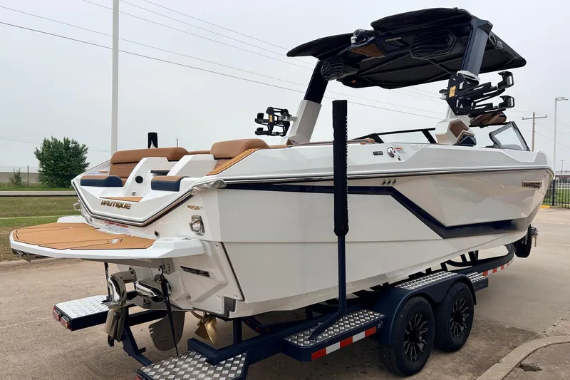 Slide: The Image of 2026 Nautique Super Air Nautique G25 boat on trailer, showcasing sleek design and modern features. - 6