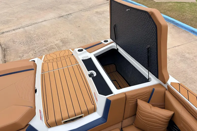 Slide: The Image of 2026 Nautique Super Air Nautique G25 boat interior with open storage compartment. - 60