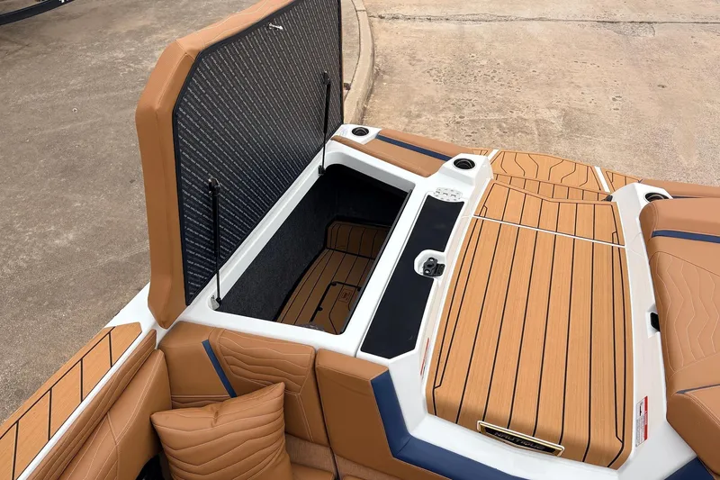 Slide: The Image of 2026 Nautique Super Air Nautique G25 boat interior with open storage compartment. - 61