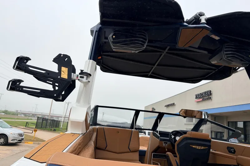 Slide: The Image of 2026 Nautique Super Air Nautique G25 boat interior with advanced wakeboard rack and premium seating. - 66