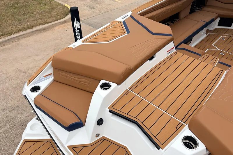 Slide: The Image of 2026 Nautique Super Air Nautique G25 boat interior with tan upholstery and sleek design. - 68