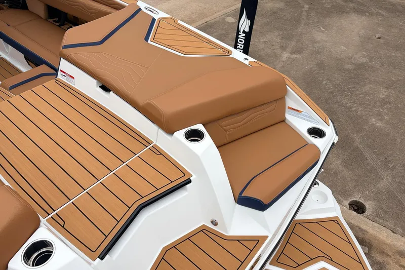 Slide: The Image of 2026 Nautique Super Air Nautique G25 boat with tan seating and teak-style decking. - 69