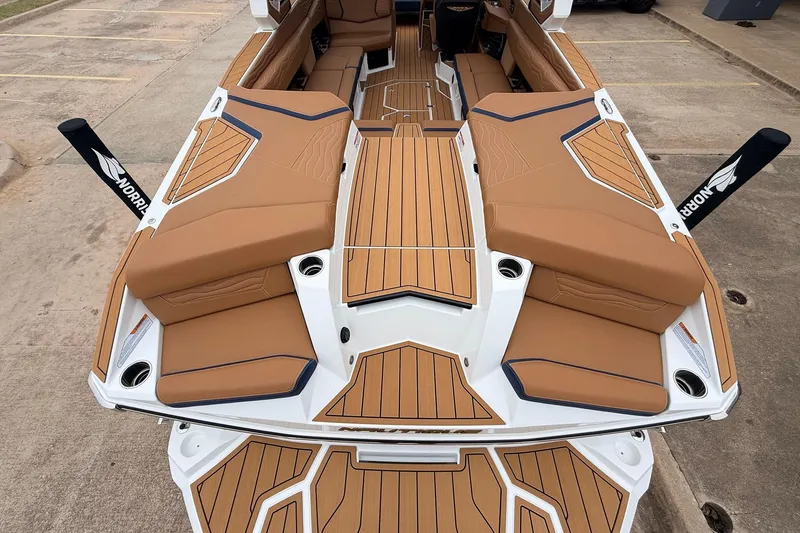 Slide: The Image of 2026 Nautique Super Air Nautique G25 boat with tan seating and teak flooring. - 70