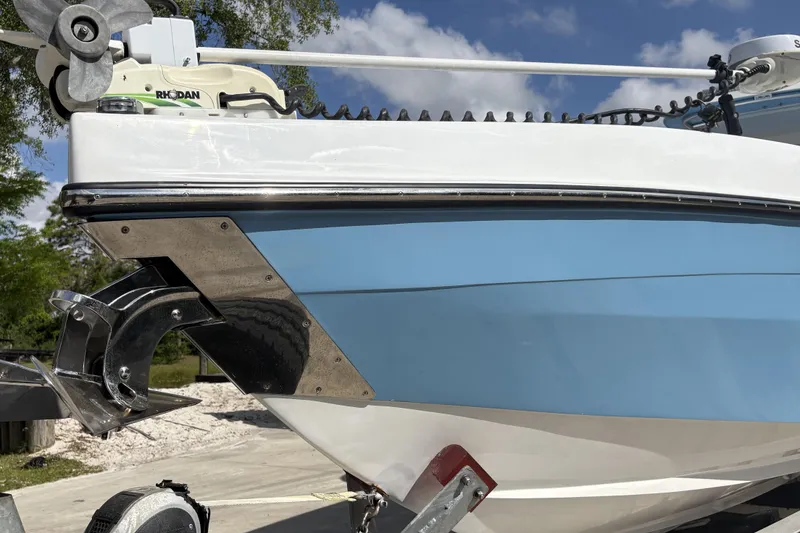 Slide: The Image of 2018 Catamaran Coaches 38 Lightning boat on trailer, featuring sleek blue and white design. - 10