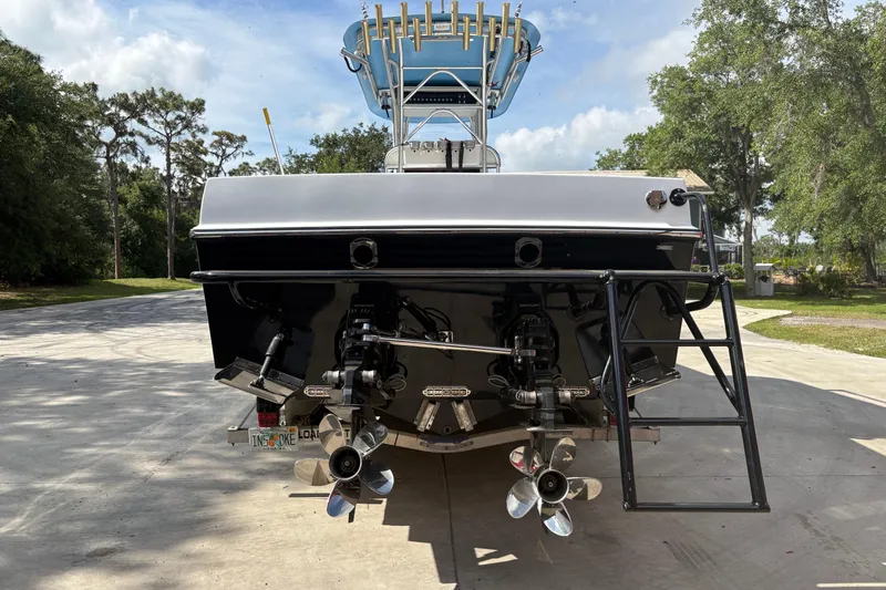 Slide: The Image of 2018 Catamaran Coaches 38 Lightning boat, rear view with dual propellers and ladder. - 14