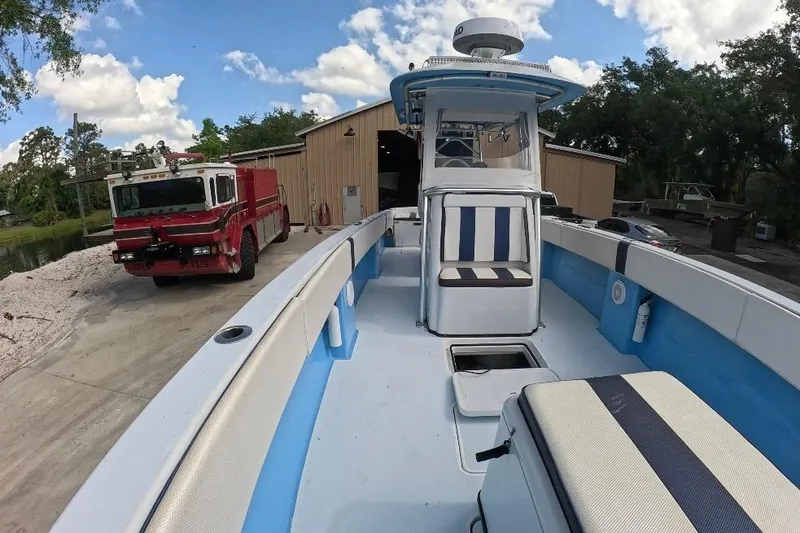 Slide: The Image of 2018 Catamaran Coaches 38 Lightning boat docked near a fire truck and building. - 20