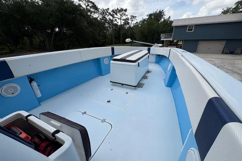 Slide: The Image of 2018 Catamaran Coaches 38 Lightning boat interior with blue and white seating, storage compartments. - 27