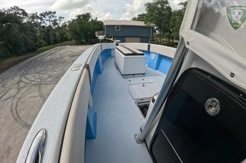 Slide: The Image of 2018 Catamaran Coaches 38 Lightning boat interior with seating and storage, parked outdoors. - 29