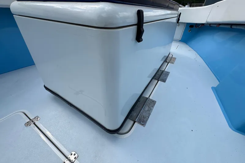 Slide: The Image of 2018 Catamaran Coaches 38 Lightning interior with storage compartment and blue flooring. - 34